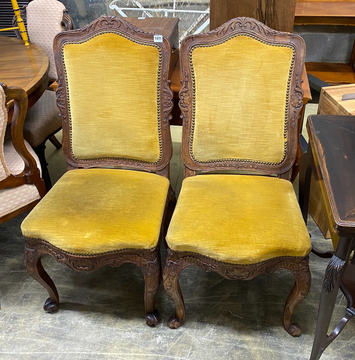 A pair of Louis XVI style upholstered carved oak dining chairs, width 46cm, depth 42cm, height 100cm